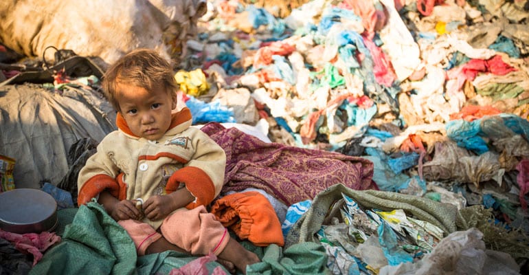 a toddler on a mountain of trash