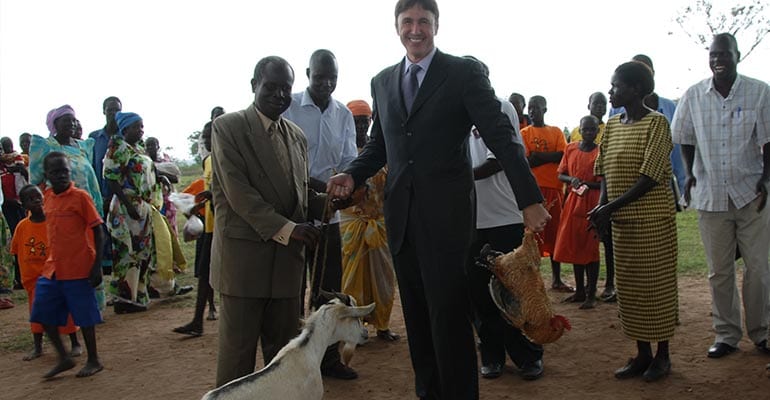 Lawrence Sizemore holding a chicken and a goat