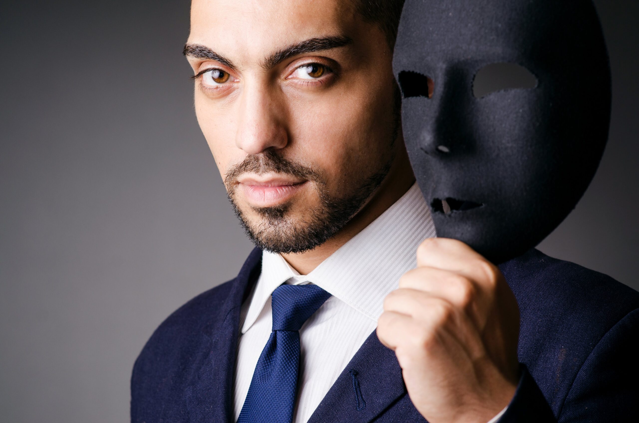 a man holding a black mask